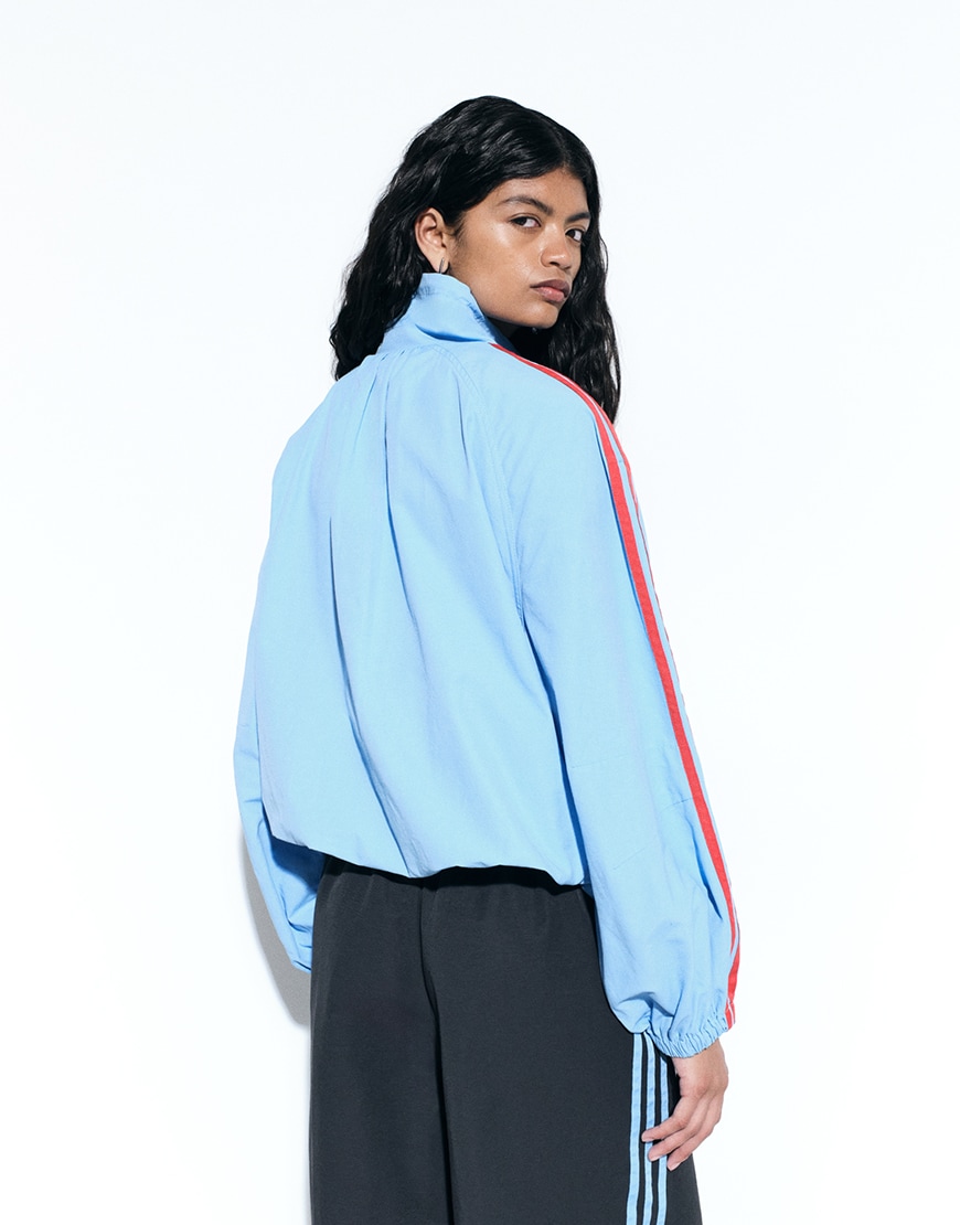 Woman wearing blue adidas track jacket and black trousers | ASOS Style Feed