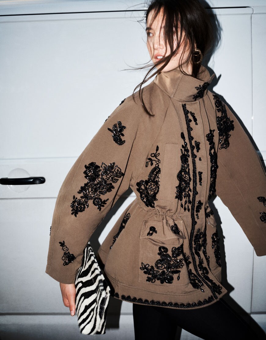 Woman wearing brown embellished jacket and zebra clutch | ASOS Style Feed